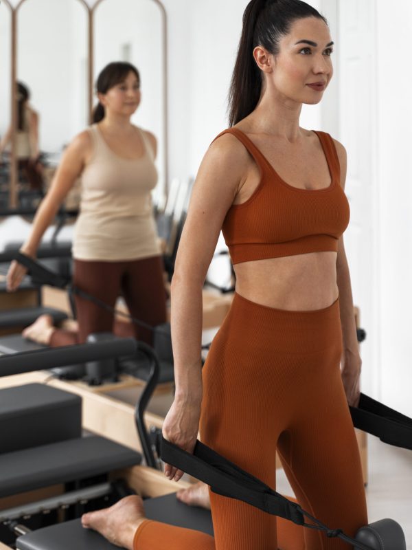 people-taking-pilates-reformer-class